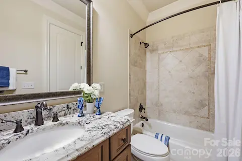 Guest suite 2 has a decorative tile surround tub/shower combo