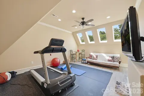 Tiled Exercise room with walk-in attic storage access