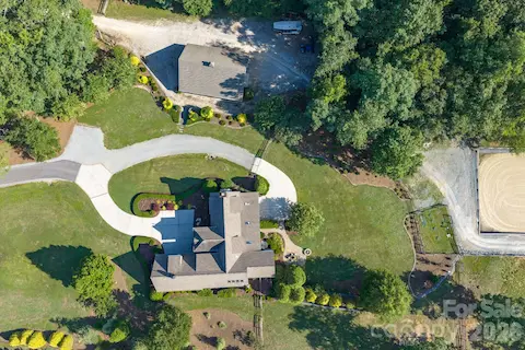 Gated entrance, paved and concrete driveway, plenty of parking