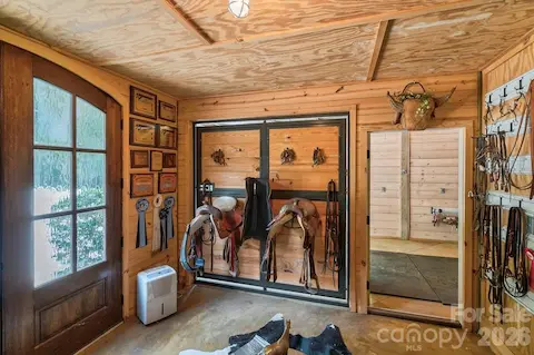 Tack room with tongue &  grove walls, glass and mahogany french doors
