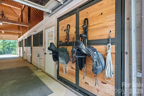 Concrete center aisle, walk up hay and storage deck, electronic garage door and sliding end doors