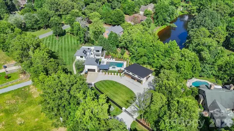 Aerial view of expansive 1.58-acre lot with resort-style backyard and modern architecture