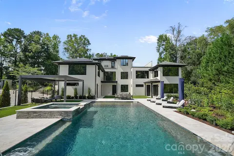 Resort-style pool with sheer-descent waterfalls, tanning ledge, built-in benches, and leathered marble deck