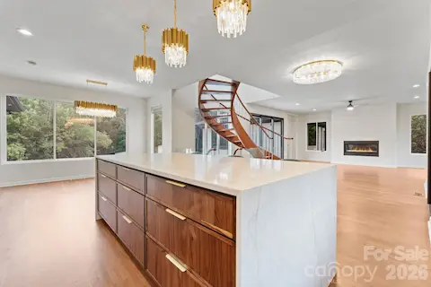 Chef's kitchen with 9-foot waterfall island, walk-in pantry access, and premium finishes