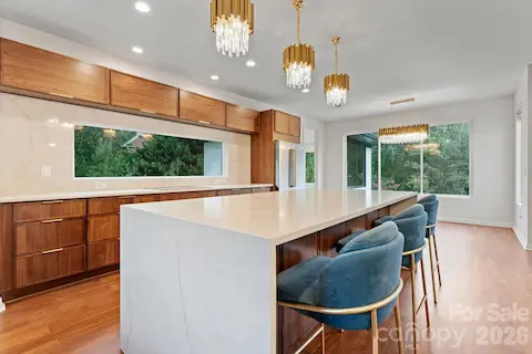 Designer kitchen with custom cabinetry, waterfall island, and professional-grade appliances