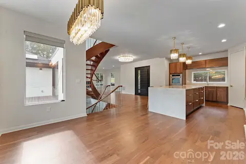Gourmet kitchen with island seating, custom oak cabinetry, and stainless steel appliances