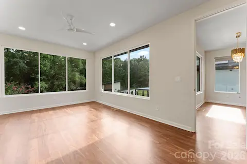 Eat-in kitchen and breakfast nook with designer lighting and oak hardwood floors