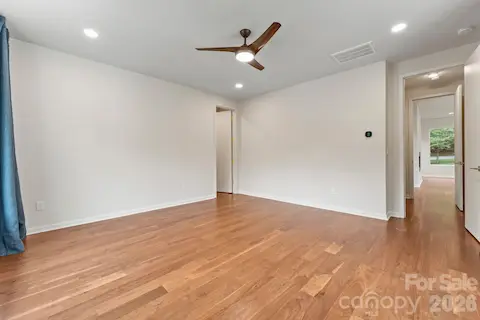 Main floor primary bedroom with walk in closet and pools views.