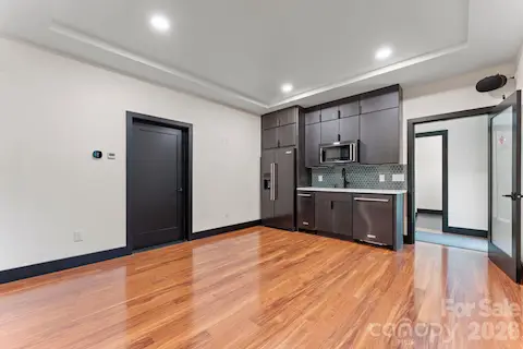 Garage guest suite / in-law apartment with full kitchenette, radiant heated floors, en-suite bath, laundry, and private entrance — perfect for multi-generational living