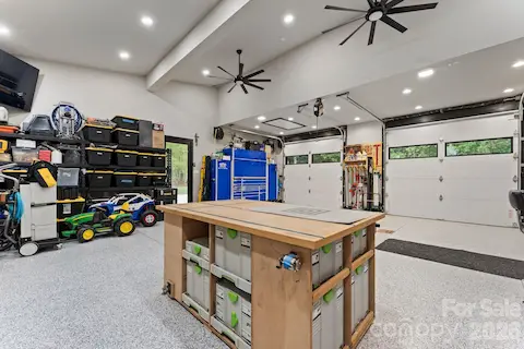 Climate-controlled finished garage with EV charging, epoxy-style polyaspartic floors, and workshop features