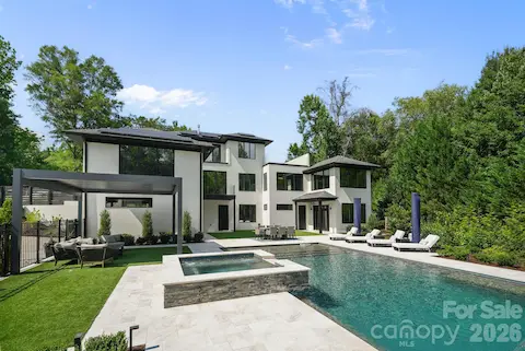 Resort-style pool with sheer-descent waterfalls, tanning ledge, and leathered marble surround