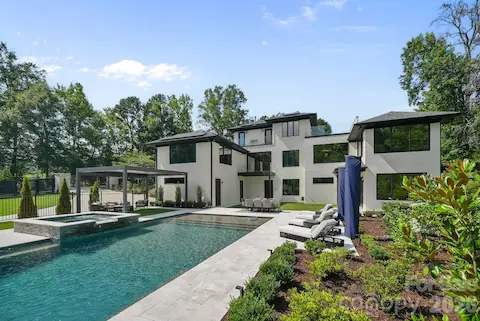 Resort-style pool with sheer-descent waterfalls, tanning ledge, and leathered marble surround