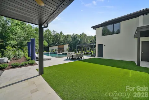 Resort style backyard with multiple turf areas and entertaining spaces