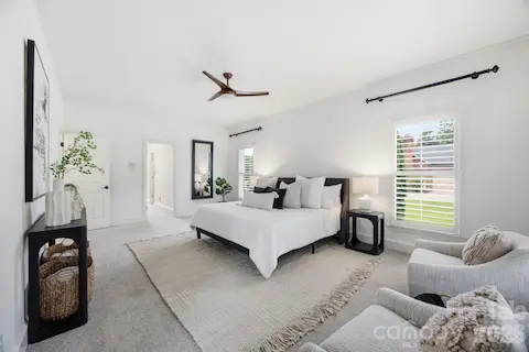 Primary bedroom suite with a lovely sitting area and door to the porch