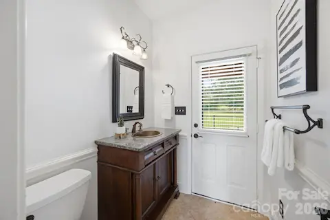 Guest power room, leads to the outdoor entertaining patio