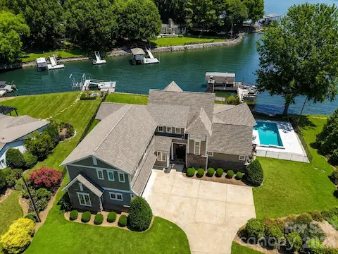 Elegant waterfront home with a private pool, dock, and breathtaking lake views, offering an exceptional blend of luxury, privacy, and Lake Norman living. (Virtually enhanced lake levels)