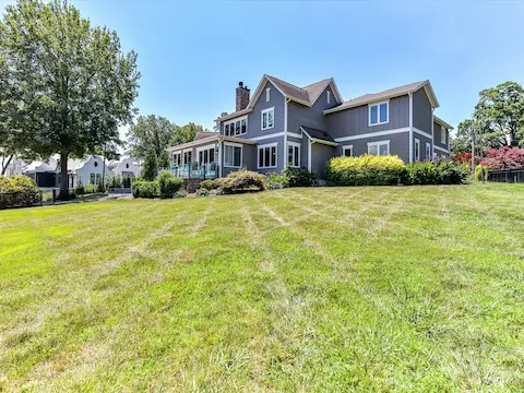 The expansive, level backyard offers plenty of space for recreation, entertaining, and enjoying peaceful lake views in a beautifully landscaped setting.