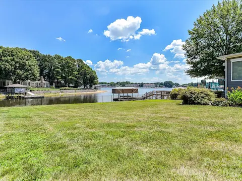The expansive, level backyard offers plenty of space for recreation, entertaining, and enjoying peaceful lake views in a beautifully landscaped setting.