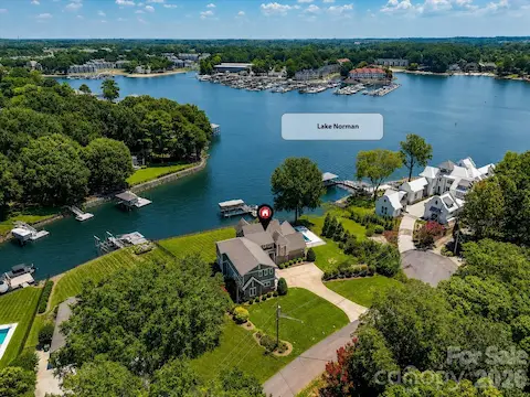 Aerial view showcasing the home's prime Lake Norman location with expansive waterfront, surrounding luxury homes, and convenient access to open water. (Virtually enhanced lake levels)