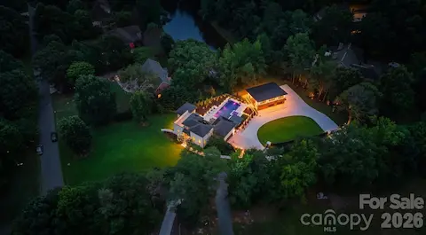 Night Aerial view of luxury 1.58-acre estate property with private gated grounds and mature landscaping