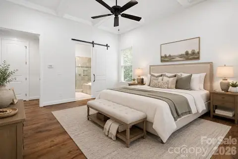 Primary BR barn door leads to en suite virtually staged
