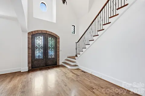 2-Story Foyer with Arched Metal Double Doors