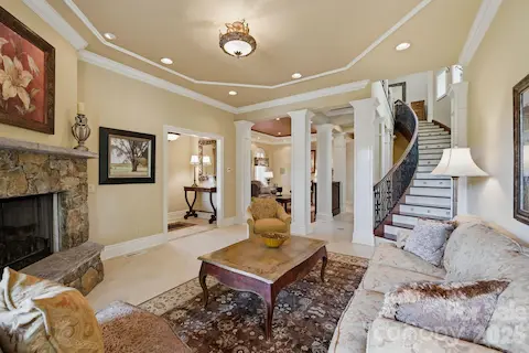 Guest house living room with lake views & cozy fireplace.