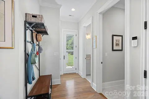 Hallway from garage leading to outside door (or pool if added), powder room and laundry room.