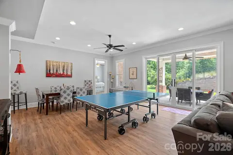 walkout basement with dining area and ping pong area leading out onto the covered patio