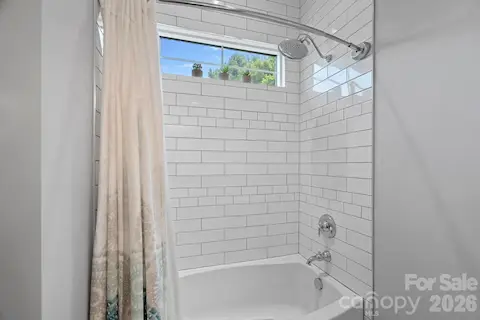 Shower area with subway tile.  jack and jill bath - walkout basement