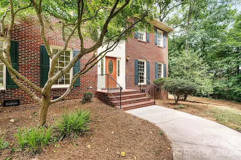 Stately front walkway leads to a warm and welcoming entrance.