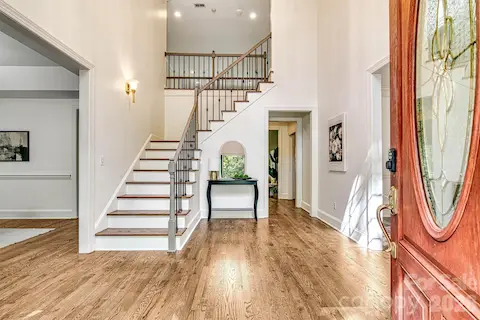 Light-filled, grand two-story foyer showcases refinished hardwoods and timeless architecture.