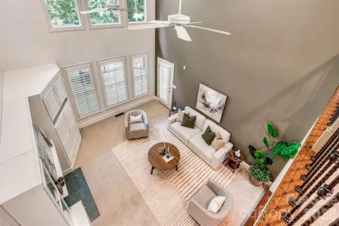Open to the upper level, this impressive family room showcases soaring ceilings and exceptional architectural design.