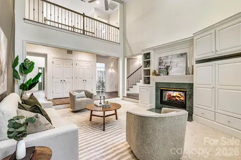 Timeless architecture is highlighted by the open catwalk, while the two-sided fireplace framed by custom built-ins anchors the room.