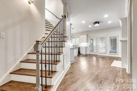 Architectural curved wood-tread staircase to the upper level.