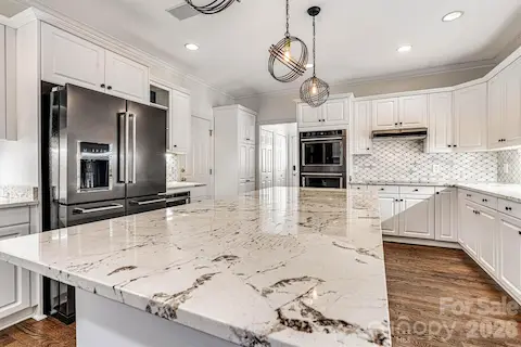 Striking natural granite with beautiful veining takes center stage.