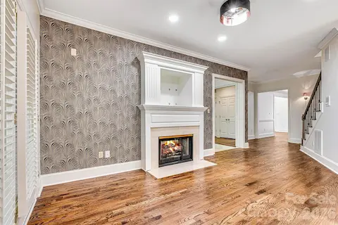 Cozy breakfast nook highlighted by an accent wall and two-sided gas fireplace