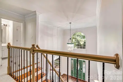 Stunning upper-level catwalk with wood railings & black iron balusters.