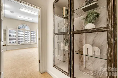 Primary suite features a built-in glass display cabinet & direct access to the bonus room.