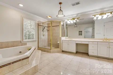 Spacious primary ensuite with double vanities, walk-in shower & jetted soaking tub.