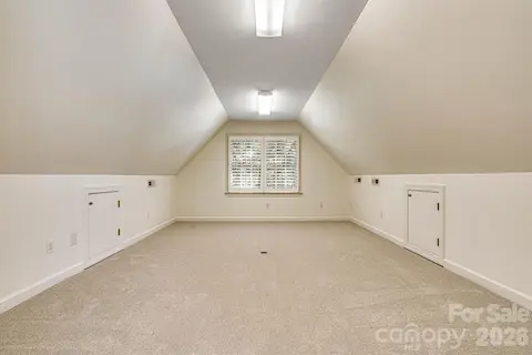 Adjoining flex room with neutral carpet extends the versatility of the bonus room.