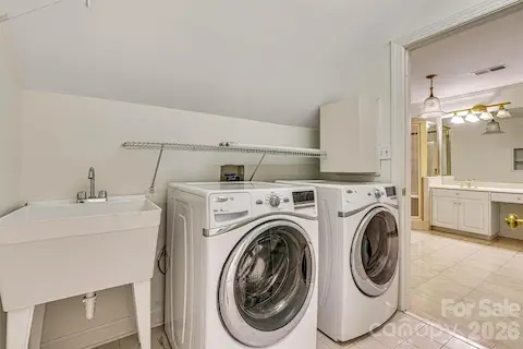 Upper-level laundry room near all three bedrooms with utility sink. Washer & dryer convey.