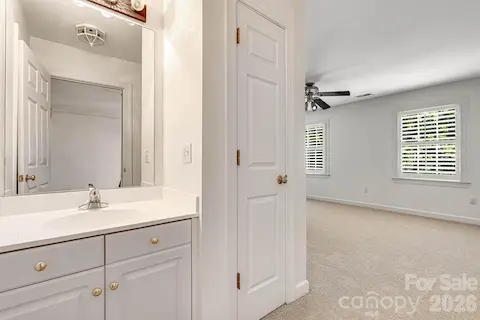 Two spacious upper-level bedrooms share a convenient Jack-and-Jill bath, with one bedroom featuring its own private vanity for added convenience.