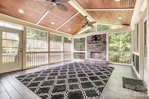 Vinyl windows and 2 ceiling fans transform this screened porch into a comfortable retreat in every season.