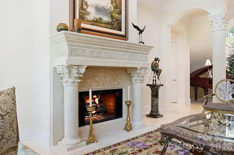 Turning toward the interior reveals the seamless connection between the great room, foyer, dining room, and kitchen. Graceful arches, decorative columns, and open sightlines give the main level an inviting flow that is ideal for both everyday living and entertaining.