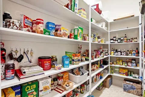 Just off the kitchen, a generous walk-in pantry provides exceptional storage with extensive built-in shelving and room to keep everyday essentials neatly organized and easily accessible.