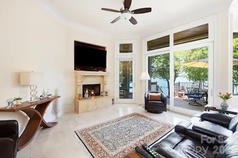 Snug between the kitchen and breakfast area, this comfortable sitting room offers a more intimate place to relax, complete with a fireplace and direct access to the lakeside terrace.