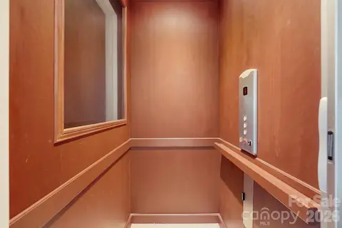 A private residential elevator provides convenient access between levels, adding an important element of comfort and accessibility to this substantial waterfront home.