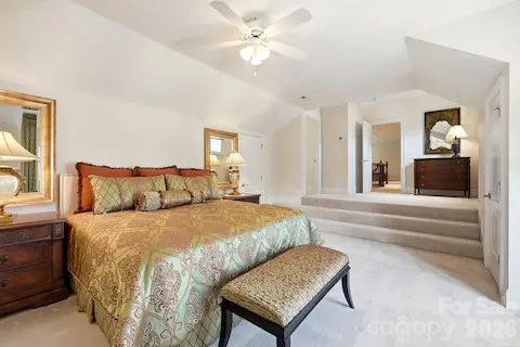 This spacious upper-level bedroom offers a private retreat with a vaulted ceiling, generous floor space, soft carpeting, and convenient access to the adjoining full bath. Its flexible layout provides plenty of room for guests, family, or an additional sitting area.