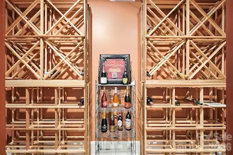 Just off the gallery, a custom wine cellar makes a memorable statement with an ornate grapevine-inspired iron-and-glass entry and extensive built-in bottle storage. It is a beautifully integrated feature for collectors and entertaining.